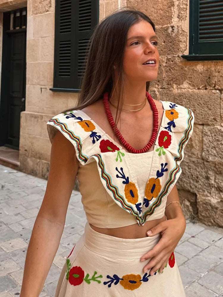 Découvrez notre ensemble tendance: un crop top imprimé avec manches volantées et décolleté carré, associé à une jupe plissée taille haute. Chic et moderne, il est idéal pour un look élégant et féminin.